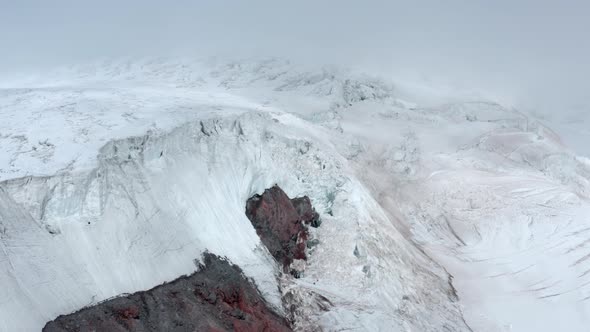 Picturesque Slope of White Elbrus Mountain with Cleft Heavy Snow Aerial View alt