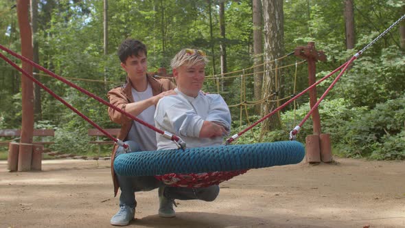 A social worker doing massage to a disabled person with congenital amputations. alt