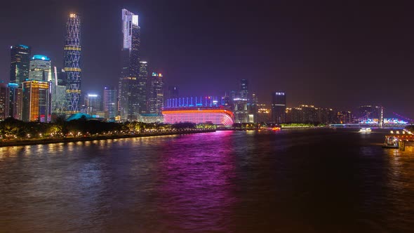 Guangzhou Night Business City Cityscape China Pearl River with Boats Traffic Timelapse Pan Up alt