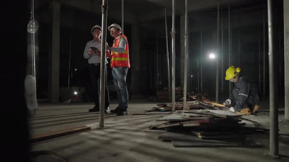 In rush work overtime, engineers and architects are consulting on a construction site