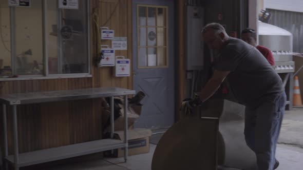 Workers wheel in concrete forms alt
