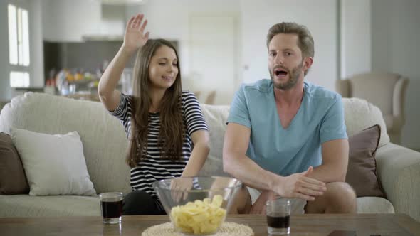 Disappointed Fan Couple on sofa alt