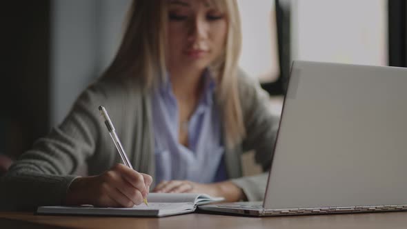 Asian Businesswoman Analyzing a Graphic of a Stock Exchange Chart alt