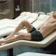 Sporty Man Relaxing at Wellness Resort. Sexy Guy Lying on Recliner in Hotel Spa.
