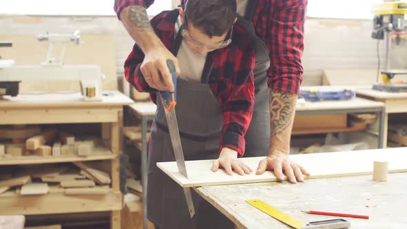 Dad and His Son Are Working in the Workshop alt