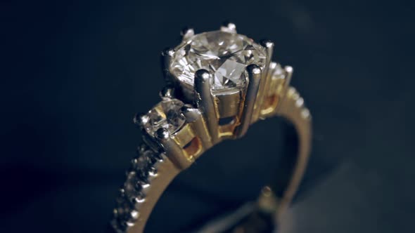 Extreme detailed of diamond ring close up shot while rotating on dark background alt