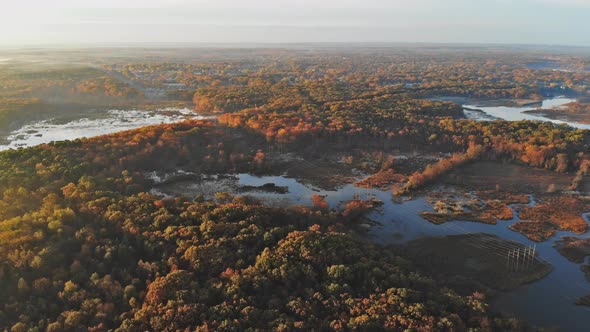 Forest in the autumn from a height on beautiful panorama of sunrise, morning fog landscape alt