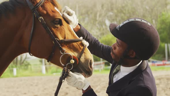 African American man caressing his Dressage horse alt