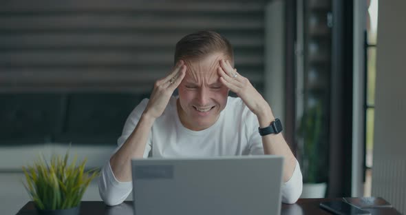 Frustrated Young Man Sitting in Front of His Laptop After Reading Bad News Says No alt
