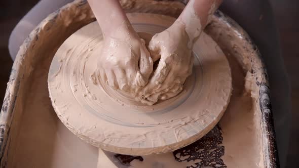 Sculptor Working with Raw and Wet Clay in Workshop Room