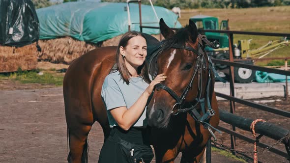 Happy Woman Stroking a Horse on a Farm in Nature at Summer Day Slow Motion alt