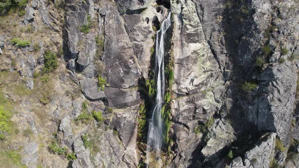 Aerial High stream water flowing down stone walls, Serra da Freita Geopark