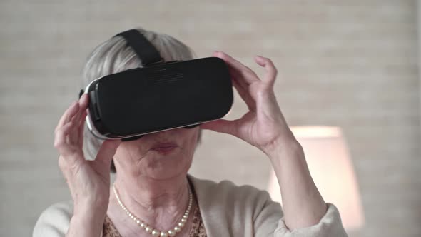 Old Woman in VR Headset Dancing with Excitement alt
