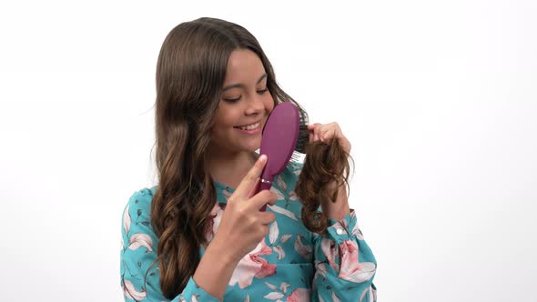 Cheerful Teen Girl Comb Long Healthy Wavy Hair with Hairbrush Showing Their Strength Hair Care alt