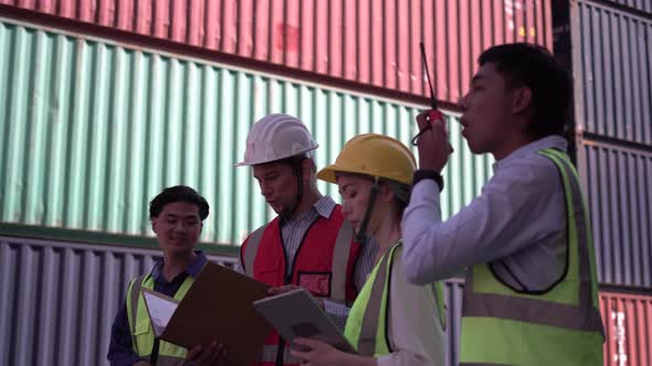 Engineer and foreman team control loading containers box from cargo, Dock worker team in a shipyard alt