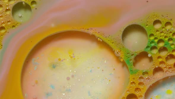 Top View Movement of Bright Oil Ink Drops Bubbles Multicolored Artistic Paint Surface Background alt