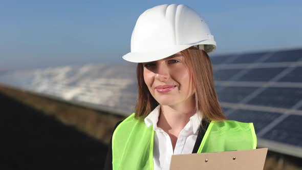A Young Female Engineer is Looking at the Camera and Smiling alt