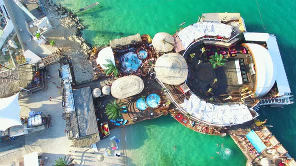 Flying above young people clubbing on zrce beach, Pag island alt