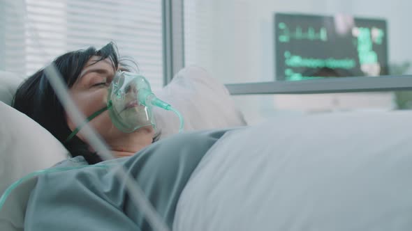 Female Patient on Ventilator with IV Drip in Medical Ward alt