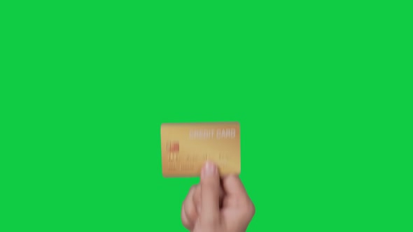 Woman customer hands holding credit card on chroma key green screen background.