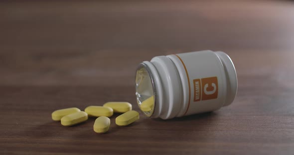 Vitamin C Pill on a Brown Table alt