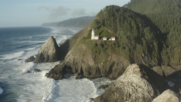 Fast tracking aerial of Haceta Head lighthouse in Oregon alt