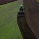 Tractor plows the ground with a plow in the field - VideoHive Item for Sale