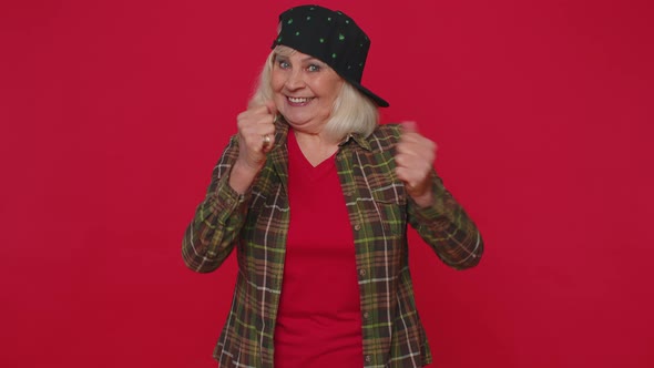 Stylish Senior Woman in Shirt Shouting Raising Fists in Gesture I Did It Celebrating Success Winning alt