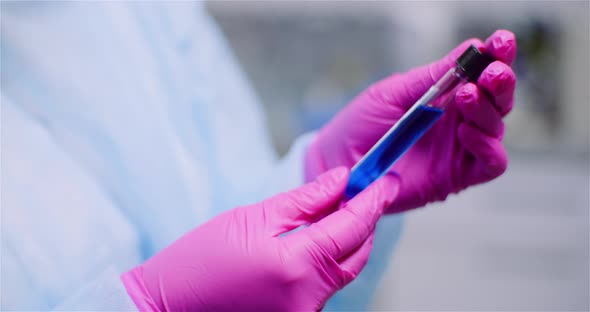Working in Lab - Scientist Holding Test Tubes. Positive Test of COVID-19 Coronavirus at Laboratory. alt