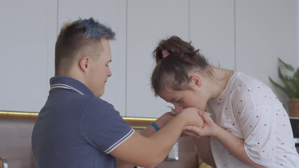 Young Couple with Down Syndrome In Love at Kitchen