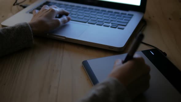 Designer Sketching On Graphic Tablet At Night alt