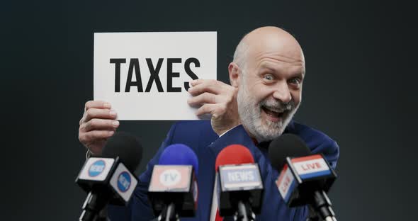 Aggressive evil politician holding a sign with taxes concept during a press coneference