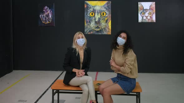 Art Gallery Visitors in Masks Having a Talk alt