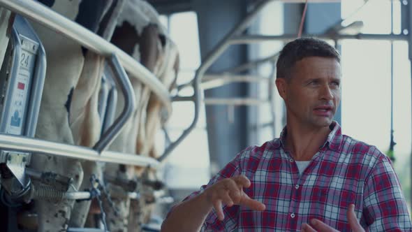 Agronomist Discussing Milk Production with Automated System on Farm Close Up alt