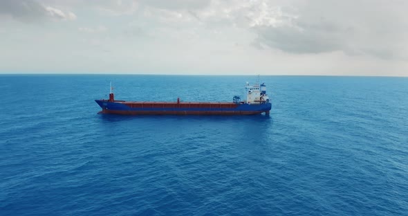 Freight Ship Floating on Sea. Aerial View. alt