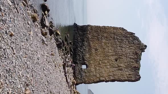 Vertical orientation video: An unusual rock standing in the sea