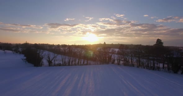 Drone sunset in snowy campain, beautiful winter sunset landscape