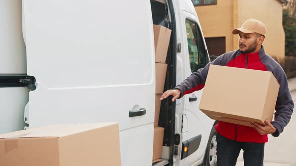 Young with Face Mask Taking a Package From the Van and Closing the Door alt