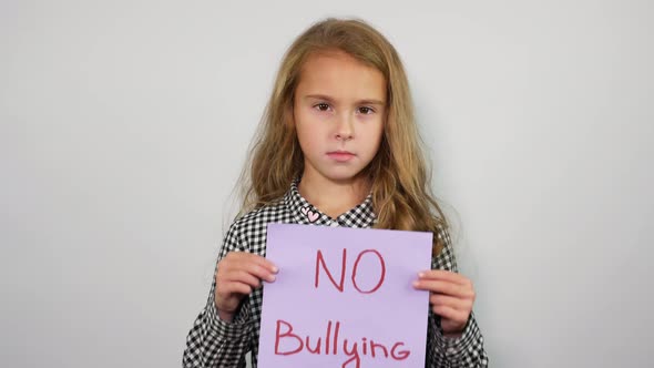 Teenage Girl Holding Paper with Inscription No Bullying alt