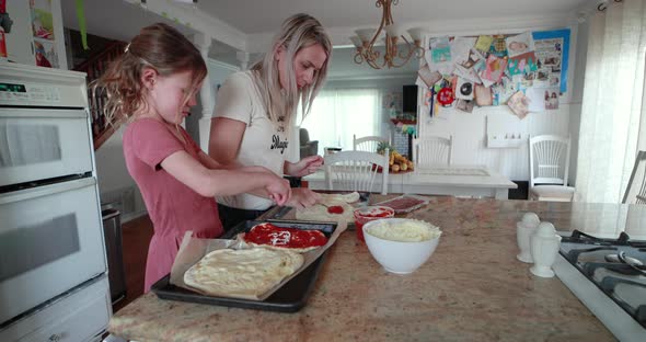 Mother And Daughter Make Pizza Together