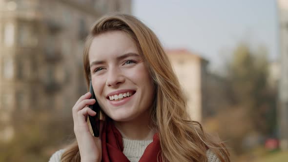 Happy Woman Calling Mobile Phone Outdoors. Smiling Girl Talking Cellphone. alt