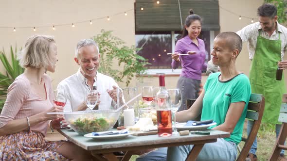 Adult Friends Enjoying Outdoor Summer BBQ at Home Garden Cooking and Having Good Times Together alt