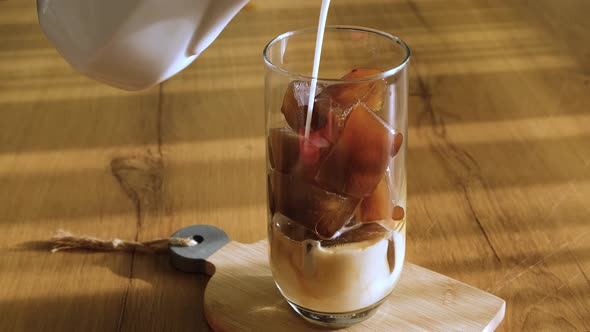 man preparing cold iced coffee in summer heat.