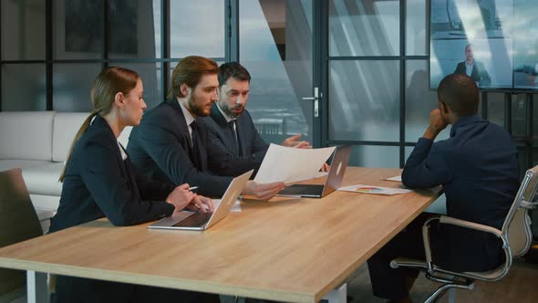 Business people at the desk in the office. Group video call alt
