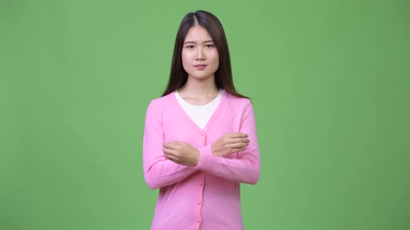 Young Beautiful Asian Woman with Arms Crossed