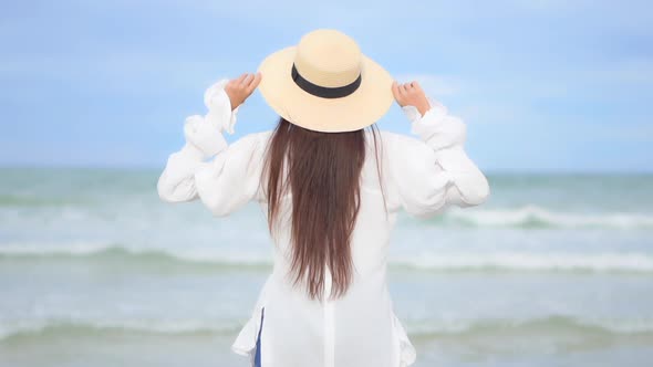 Asian woman enjoy around beautiful beach sea ocean alt
