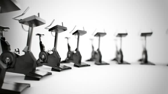 Gym equipment stationary bikes standing in the circular array. Loopable. HD alt