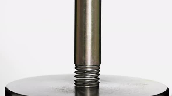 Test of Reliability of a Spring, Compression and Decompression By a Hydraulic Press, Close-up alt
