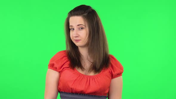 Portrait of Cute Girl Coquettishly Smiling While Looking at Camera. Green Screen alt