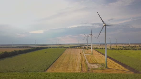 Aerial View of Wind Turbine Generators in Field Producing Clean Ecological Electricity alt